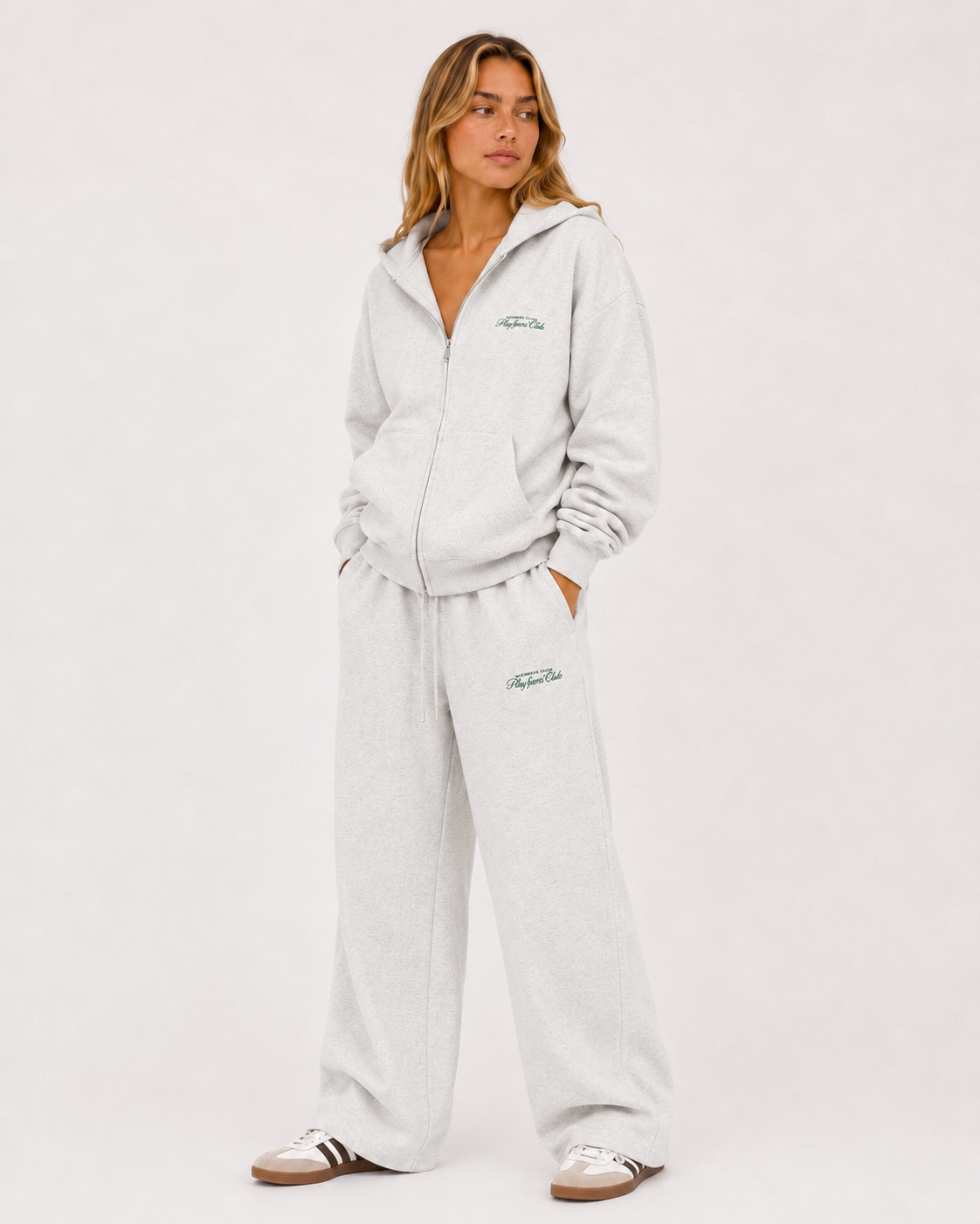 Members Club Sweatpants in grey marle worn, side view showing the drape over the shoe